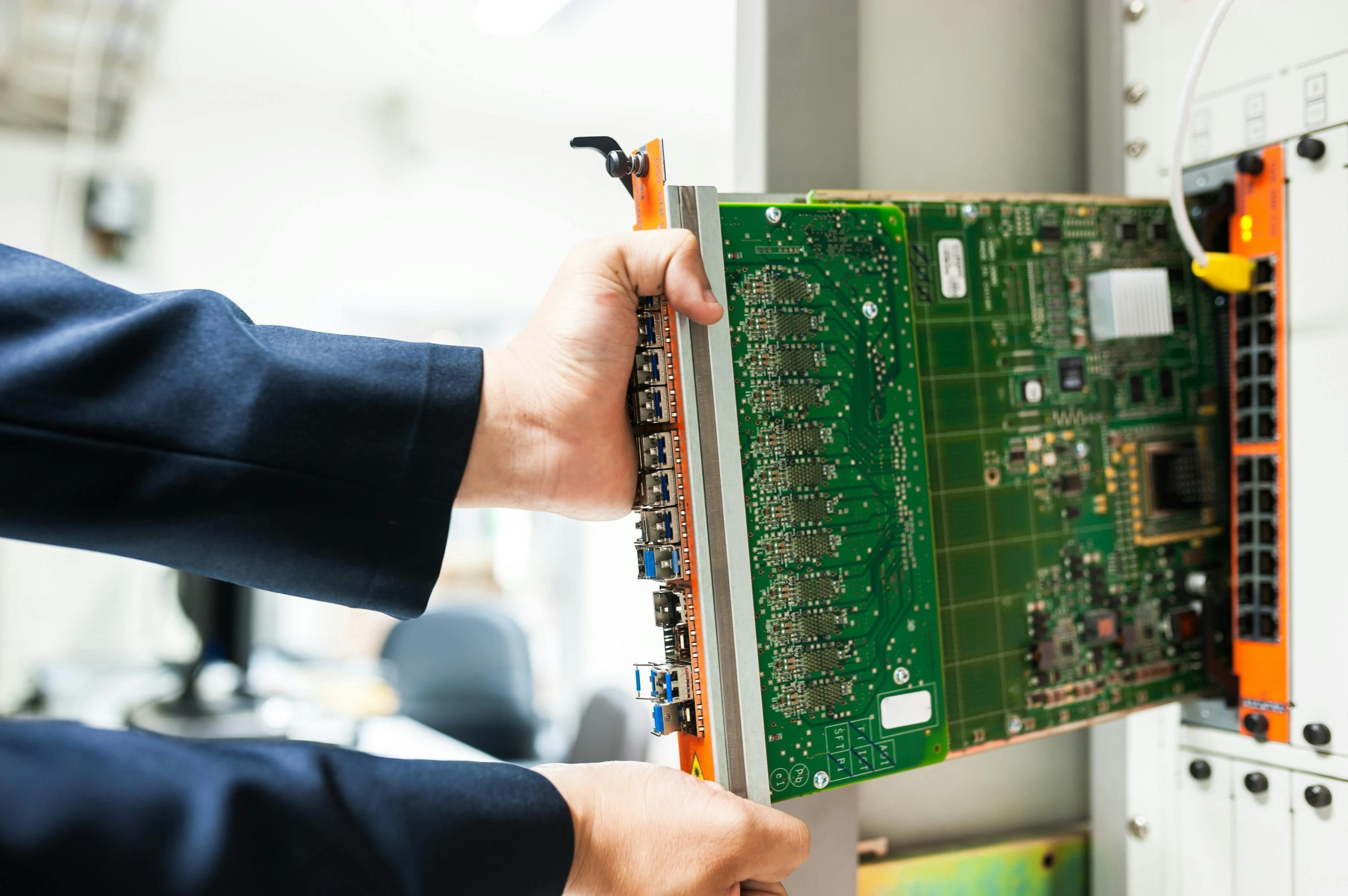 IT professional inspecting a server circuit board for data center solutions