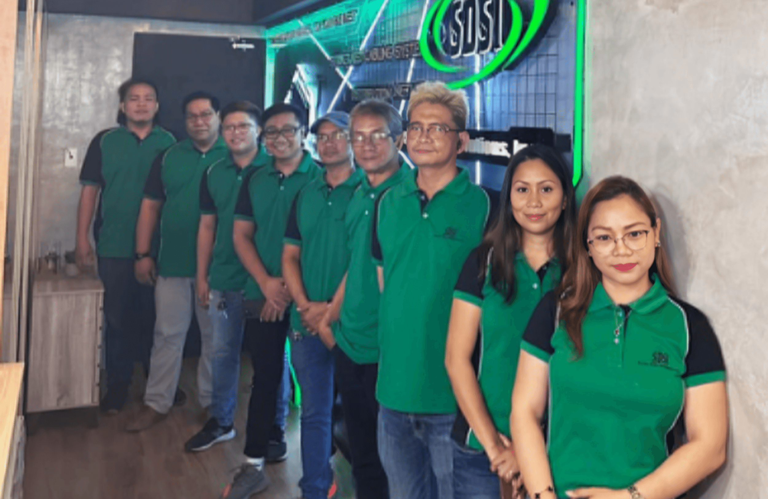 SDSI company team members standing together in the office