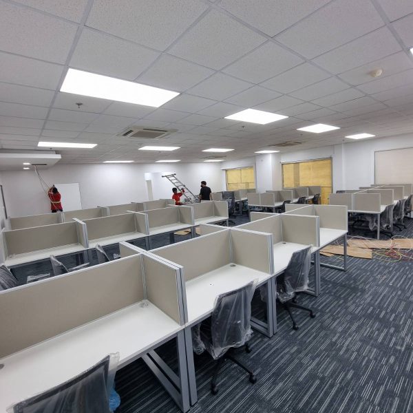 Wide view of newly assembled office cubicles and desks in a commercial workspace