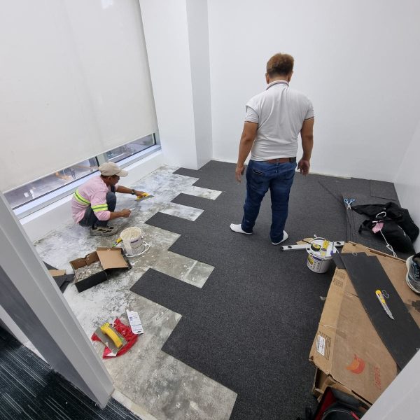 SDSI construction workers installing flooring during a modern office fit-out project